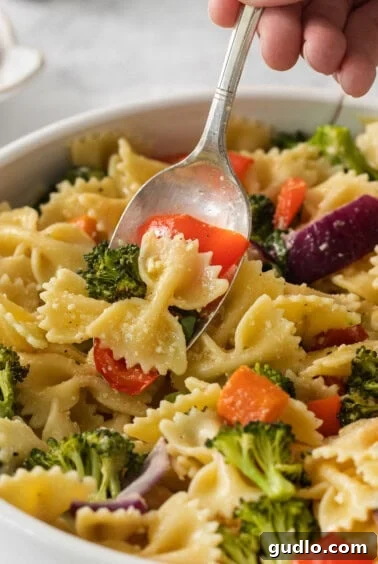 Farfalle Fiesta Salad 14 a bowl of pasta with broccoli and carrots.