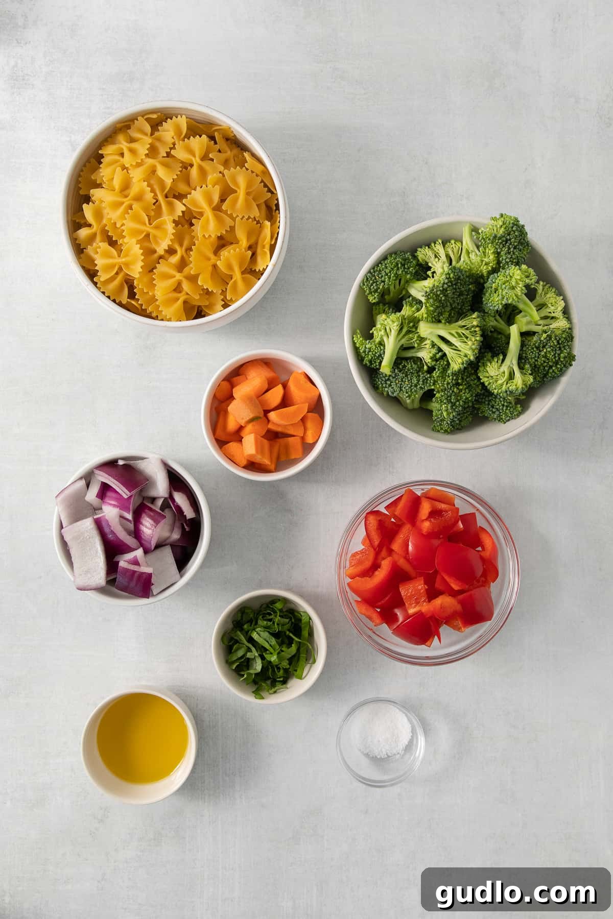 Farfalle Fiesta Salad 3 a table topped with bowls filled with different types of food.