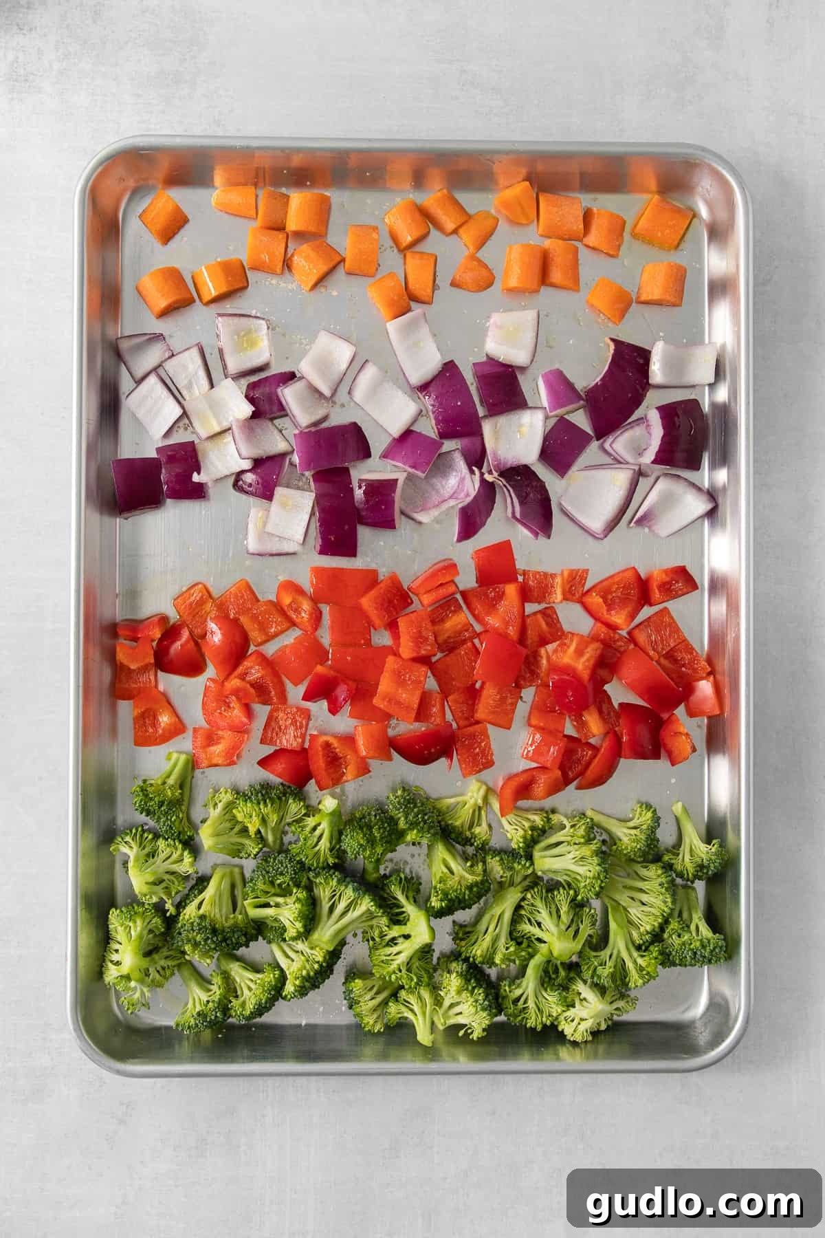 Farfalle Fiesta Salad 4 a tray of chopped vegetables including broccoli and carrots.