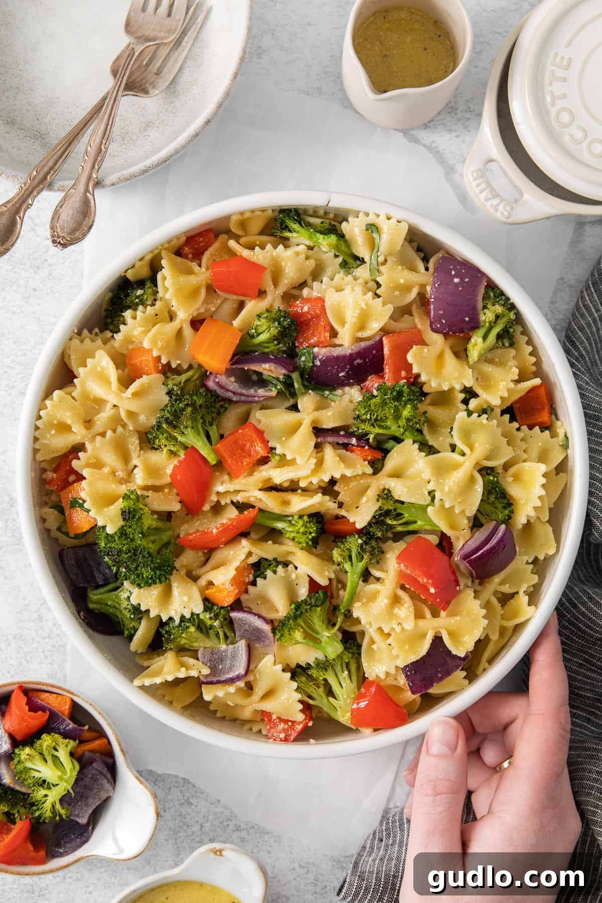Farfalle Fiesta Salad 7 a bowl of pasta salad with broccoli and carrots.