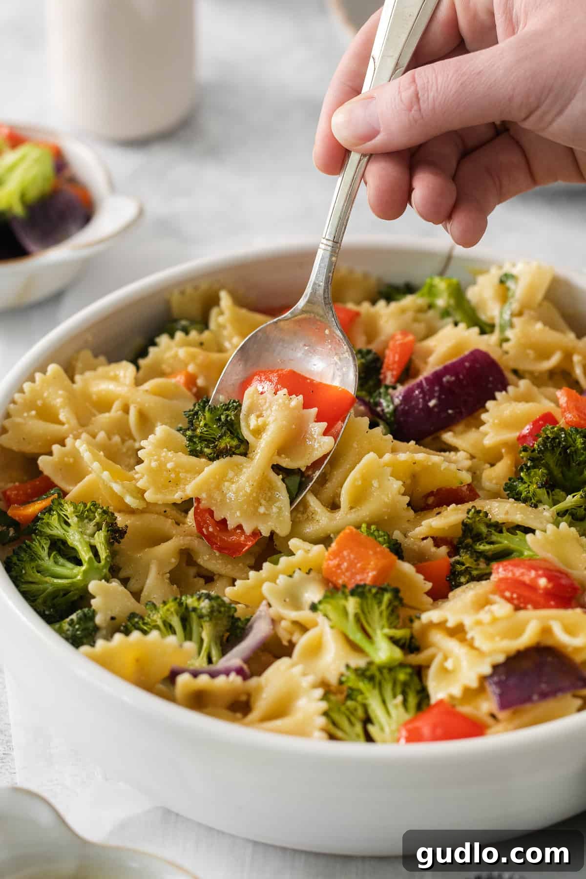 Farfalle Fiesta Salad 8 a bowl of pasta with broccoli and carrots.