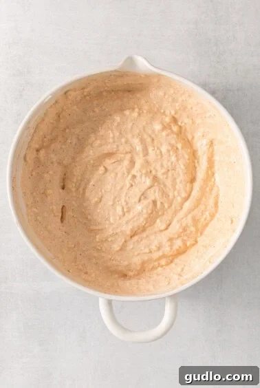 Ultimate Cream Cheese Corn Dip 11 A bowl of creamy mixture being whisked.