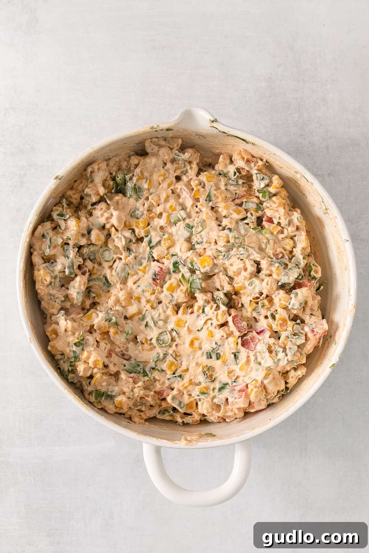 Ultimate Cream Cheese Corn Dip 7 A vibrant casserole dish filled with baked corn and cheese, an inspiration for serving the dip.