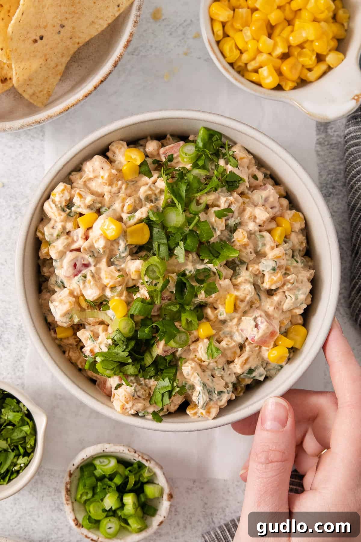 Ultimate Cream Cheese Corn Dip 8 A bowl of creamy corn dip, garnished and ready for serving, showcasing its appealing texture.
