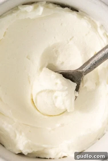 A bowl of freshly made whipped cream, smoothed with a spoon, ready for chilling or serving.