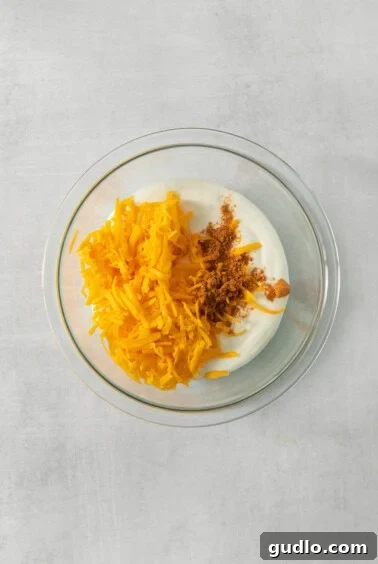 A bowl of yogurt with shredded carrots and granola, metaphorically representing the creamy texture after blending and the mix of ingredients.