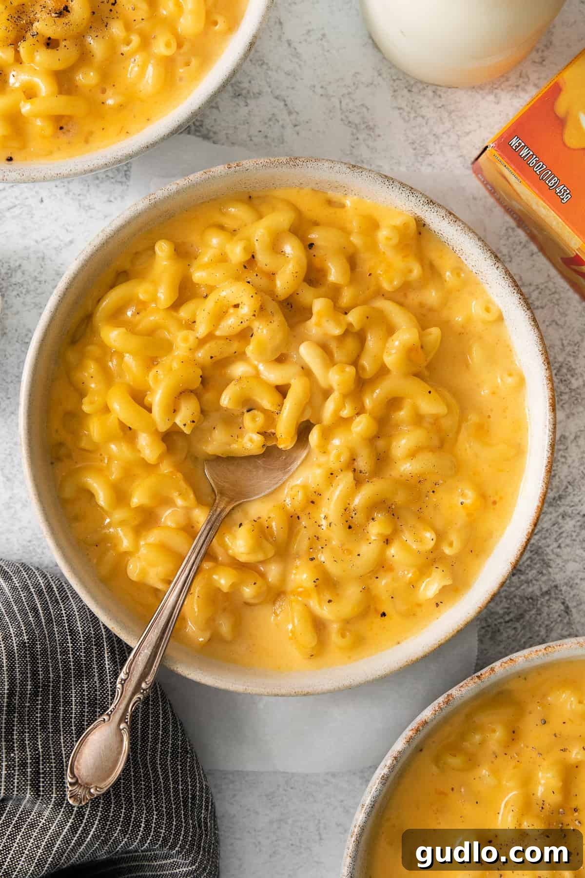Ultimate Velveeta Crockpot Mac and Cheese 2 a bowl of macaroni and cheese with a spoon.