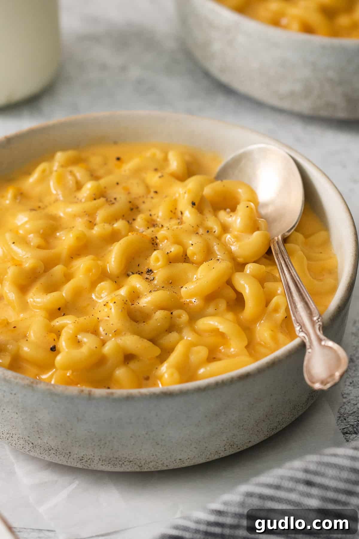 Ultimate Velveeta Crockpot Mac and Cheese 9 macaroni and cheese in a bowl with a spoon.