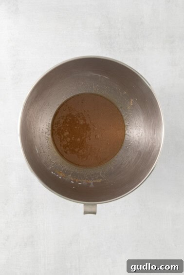 Decadent Cream Cheese Banana Bread Muffins 9 Browned butter and sugars mixed in a metal bowl on a white surface.