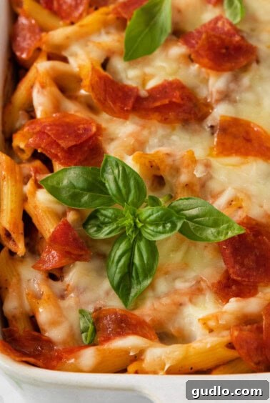 A freshly baked casserole dish with bubbling pepperoni and melted cheese, ready to be served.