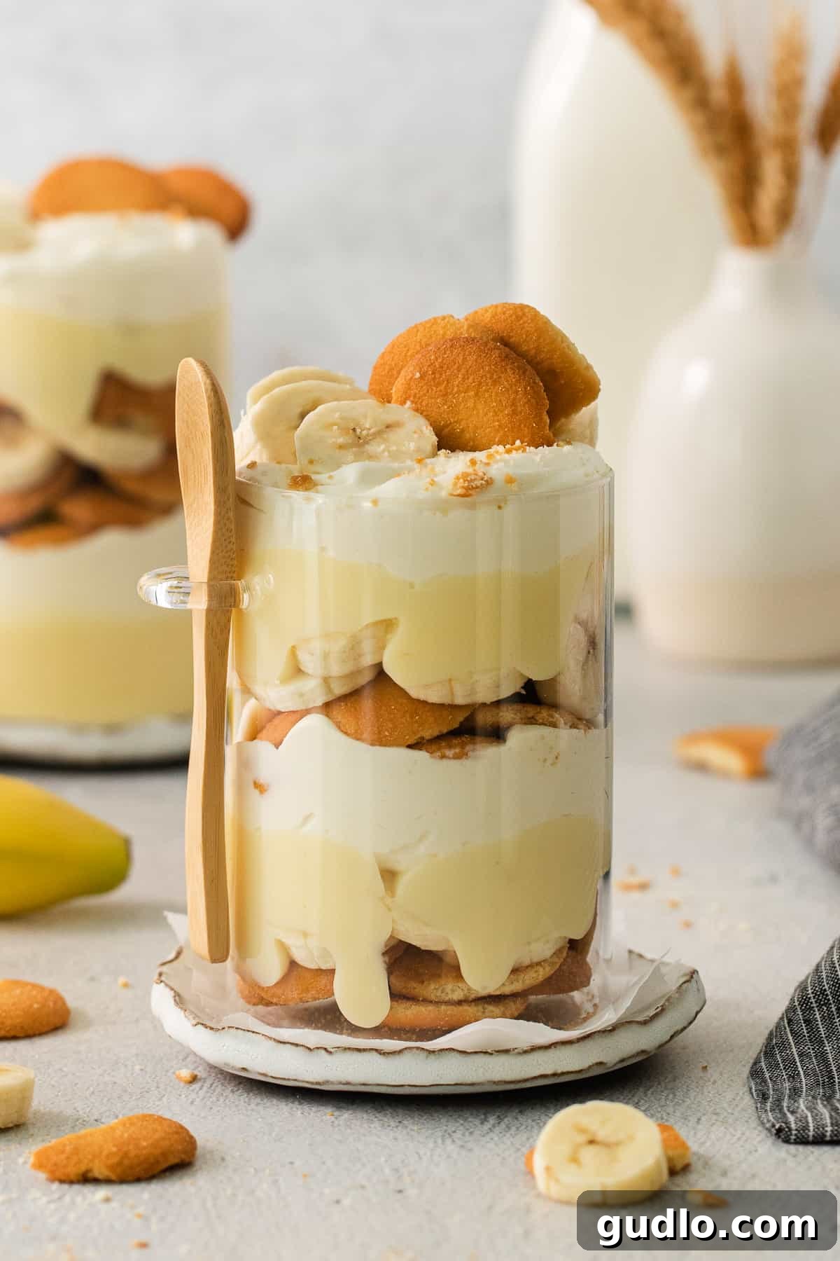 Decadent Banana Cream Cheese Pudding 2 A beautifully layered banana pudding dessert, showcasing creamy white layers and slices of fresh banana, served on an elegant plate.