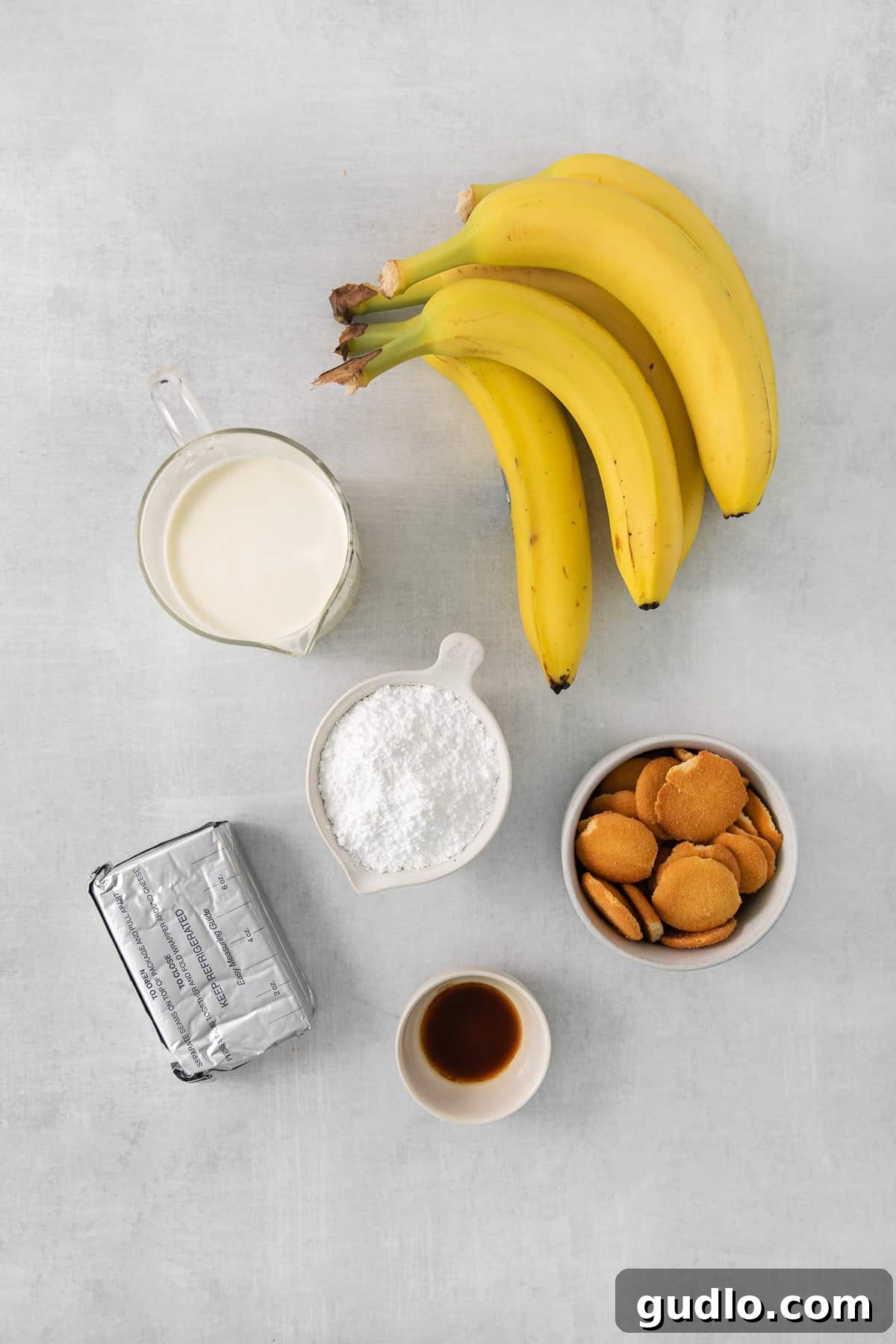 Decadent Banana Cream Cheese Pudding 3 A vibrant display of fresh, ripe bananas next to a bowl of almonds, hinting at natural ingredients used in the recipe.