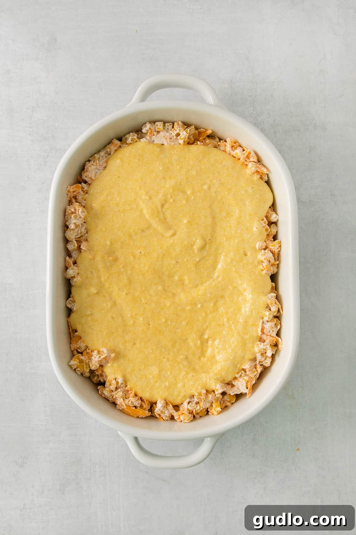 a casserole dish filled with a mixture of cheese.