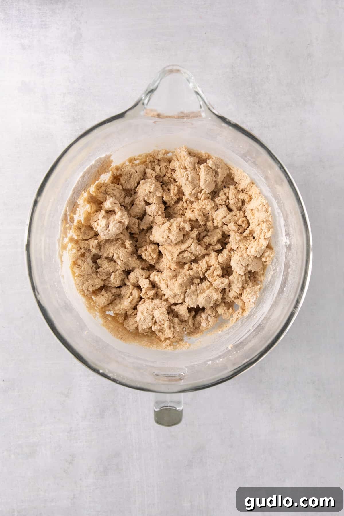 Caramel Apple Cheesecake Cookies 5 A food processor bowl containing a mixture of shredded apples, ready to be incorporated into the cookie dough.