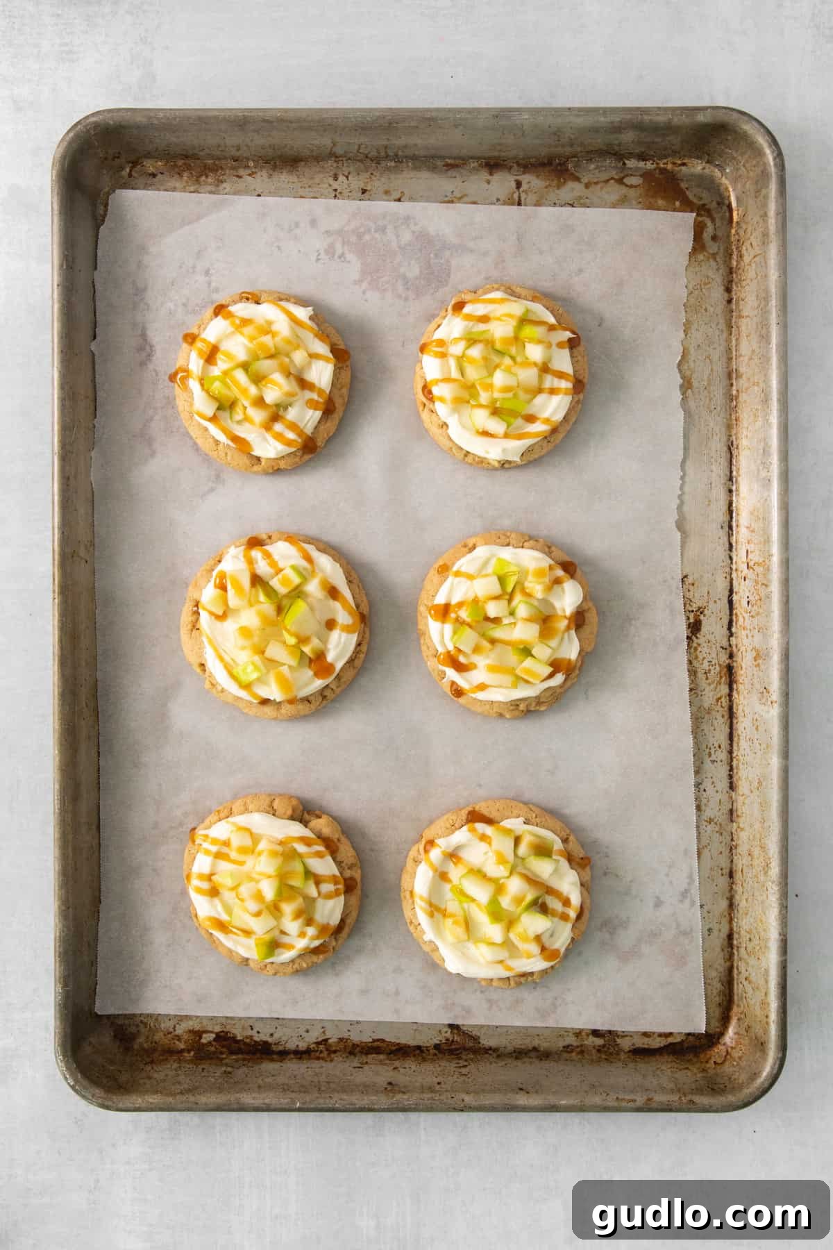 Caramel Apple Cheesecake Cookies 7 A festive baking tray filled with mini cream cheese caramel apple cookies, beautifully garnished and ready for serving.