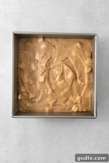 Swirled Apple Cream Cheese Coffee Cake 12 A pan filled with the raw coffee cake batter, before any filling or topping.