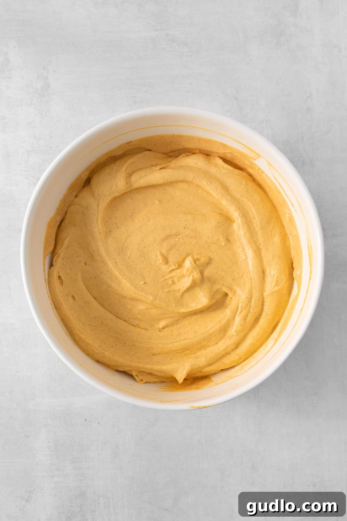 A close-up of the pumpkin mousse mixture, showing its smooth, creamy consistency and ready to be chilled before serving.