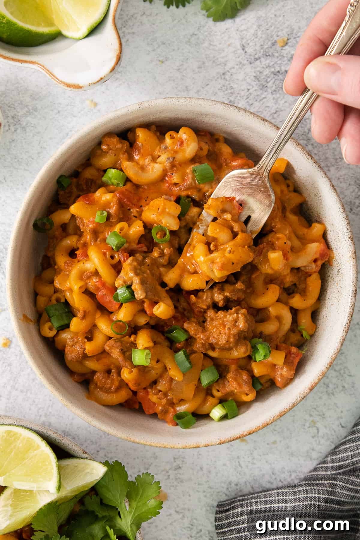 Ultimate Chili Mac and Cheese 2 A steaming bowl of vibrant chili mac and cheese, ready to be enjoyed with a spoon.