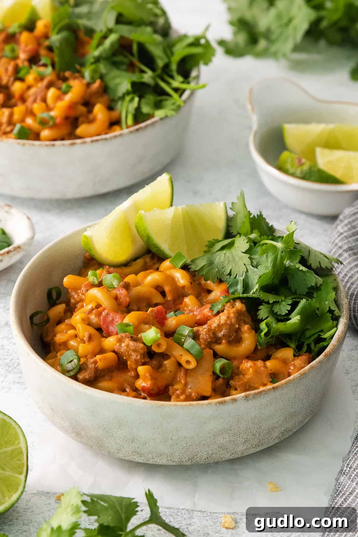 Ultimate Chili Mac and Cheese 8 Two bowls brimming with rich pasta, savory meat, and colorful vegetables, offering a delightful meal.