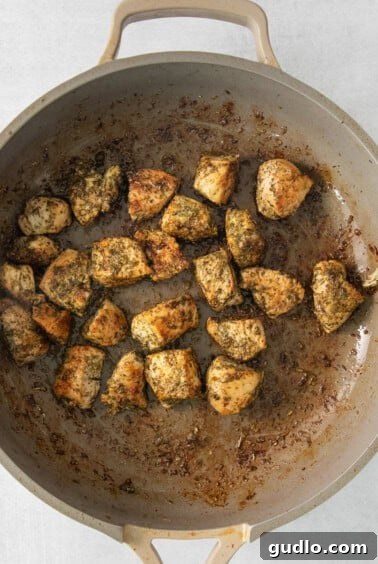 A pan filled with perfectly seared chicken pieces.