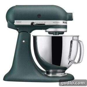 Lush Cream Cheese Frosting for Cinnamon Rolls 3 A stylish dark green KitchenAid stand mixer with its mixing bowl and paddle attachment, ready for whipping frosting.
