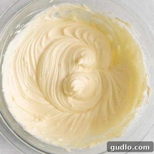 Perfectly whipped cream cheese icing in a clean white bowl, ready to be used as a delicious topping.