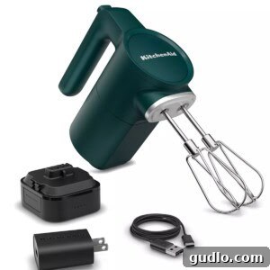 Dreamy Cherry Cream Cheese Pie 3 A green KitchenAid hand mixer with various attachments, ready for use in a kitchen.