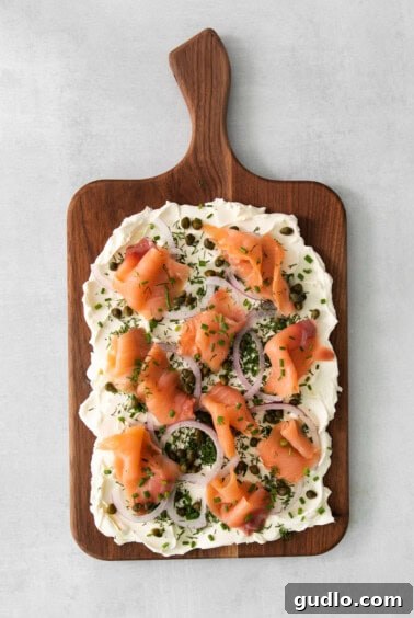 Smoked salmon pieces arranged on the cream cheese board.