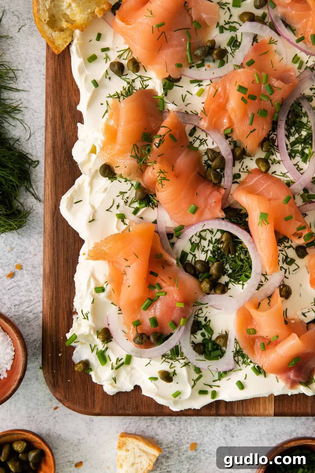 A close-up shot highlighting the quality of the smoked salmon pieces beautifully arranged on a wooden board, ready for serving.