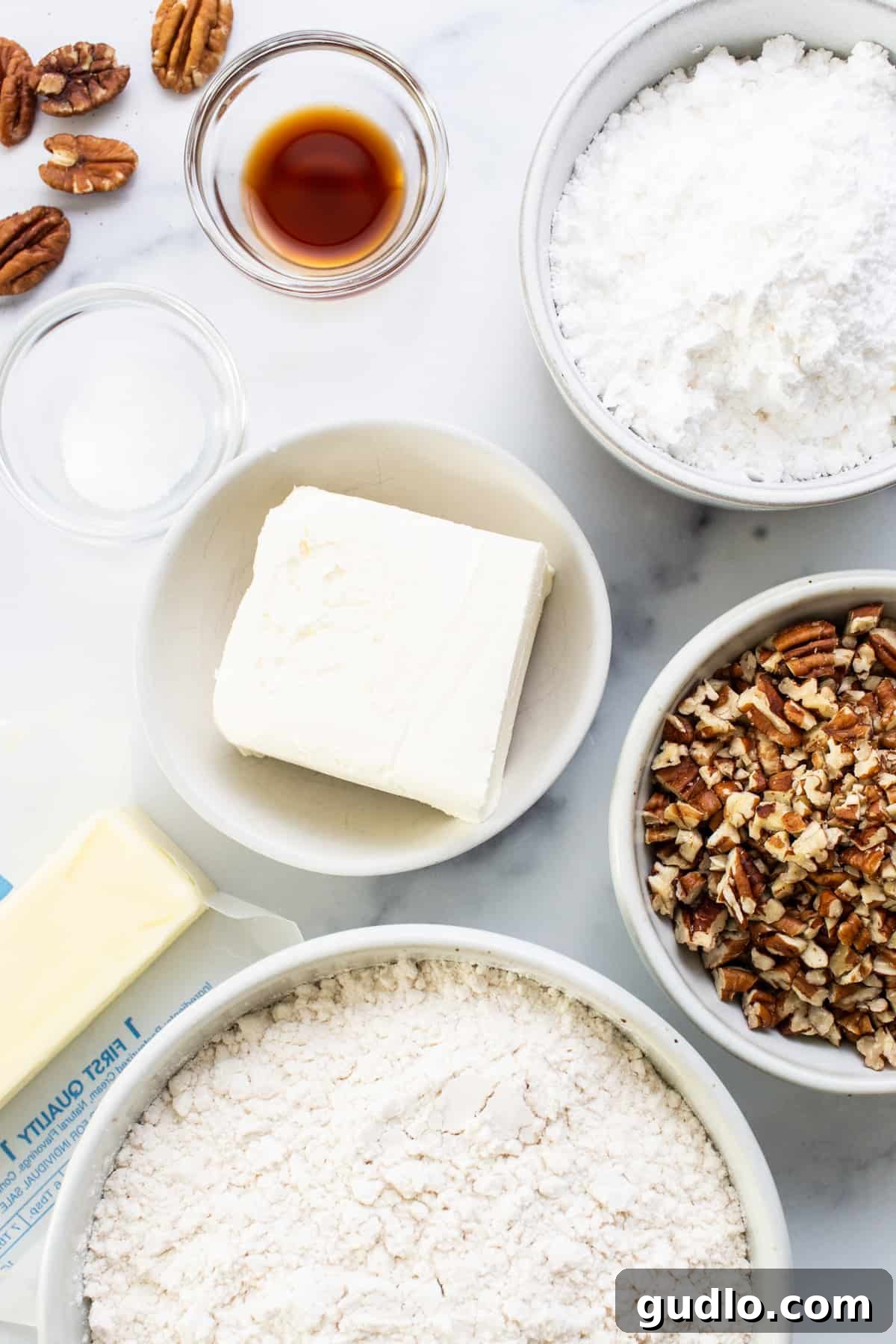 A rustic bowl filled with flour, sugar, butter, and chopped pecans, ready for mixing.