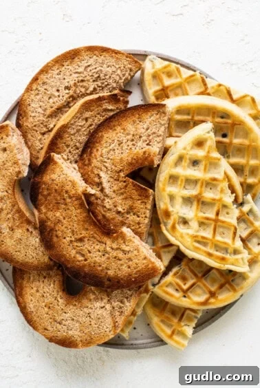 Perfectly toasted waffle halves arranged on a plate, ready to be added to the charcuterie board, showing their inviting texture.