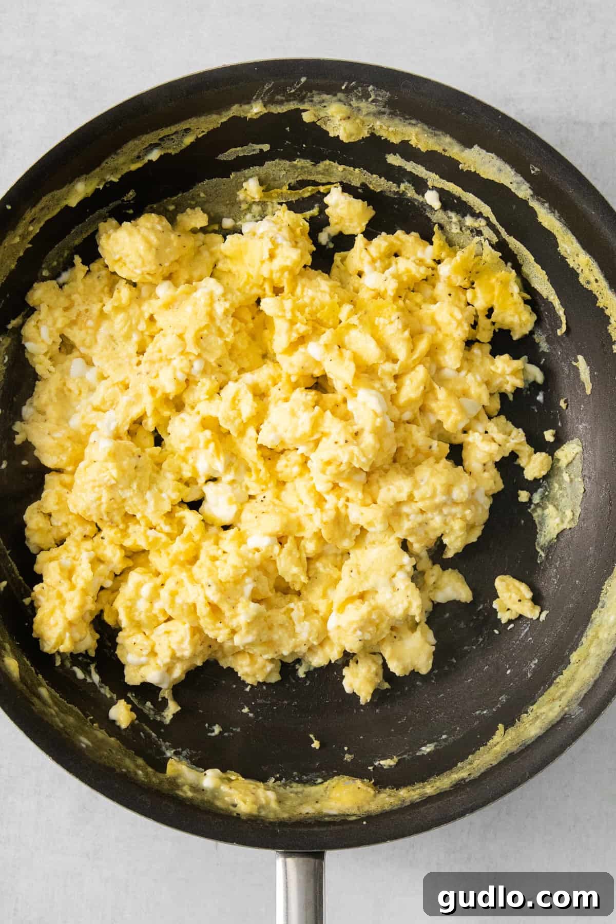 Scrambled eggs in a frying pan.