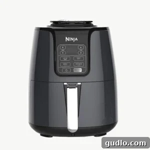 No-Fuss Air Fryer Nachos 4 A sleek black Ninja air fryer sits prominently on a pristine white background, ready for action.