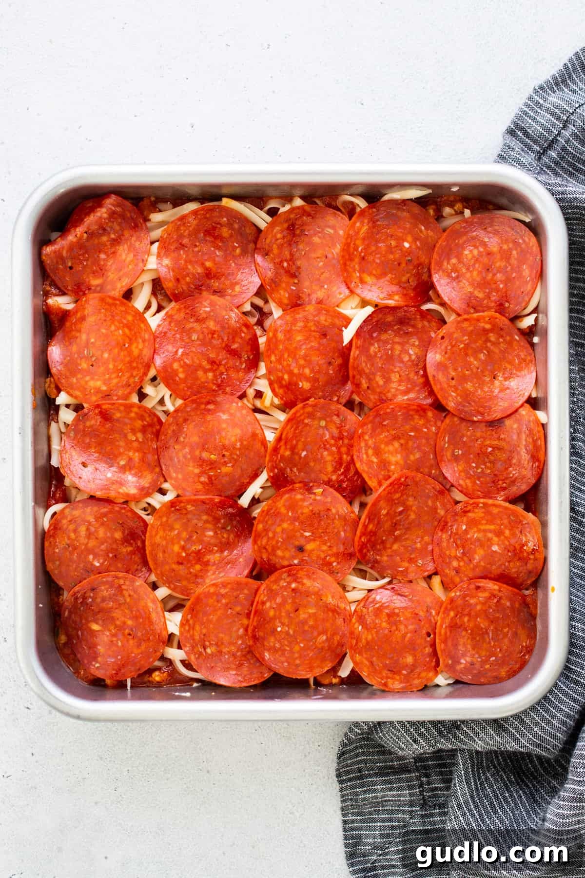 Baked Cheesy Pizza Dip with Toasted Focaccia 4 Pepperoni pizza dip bubbling in a baking dish.