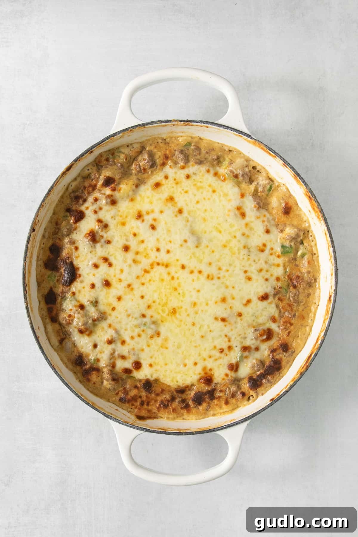 Decadent Philly Cheesesteak Dip 4 The delicious Philly Cheesesteak Dip bubbling and golden-brown fresh out of the oven in a casserole dish.