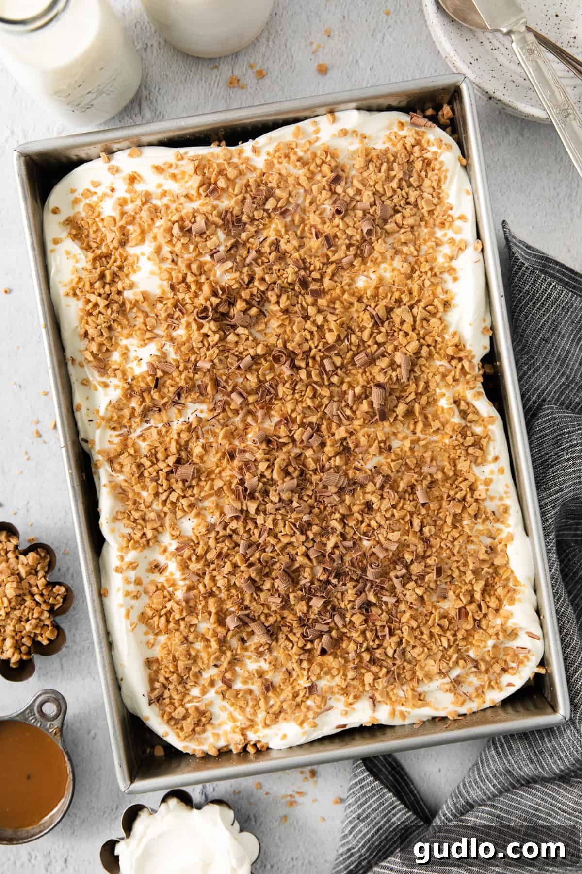 Ultimate Indulgence Cake 4 A beautifully topped dessert, featuring layers of creamy goodness and a crunchy granola-like topping, suggesting a delicious variation on a classic treat, ready for customization.