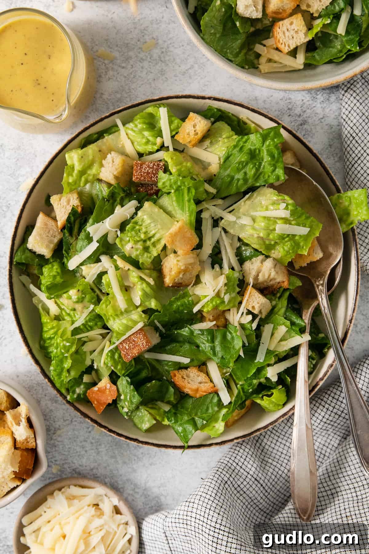 A vibrant bowl of classic Caesar salad, generously topped with golden croutons and our signature creamy dressing, ready to be enjoyed.