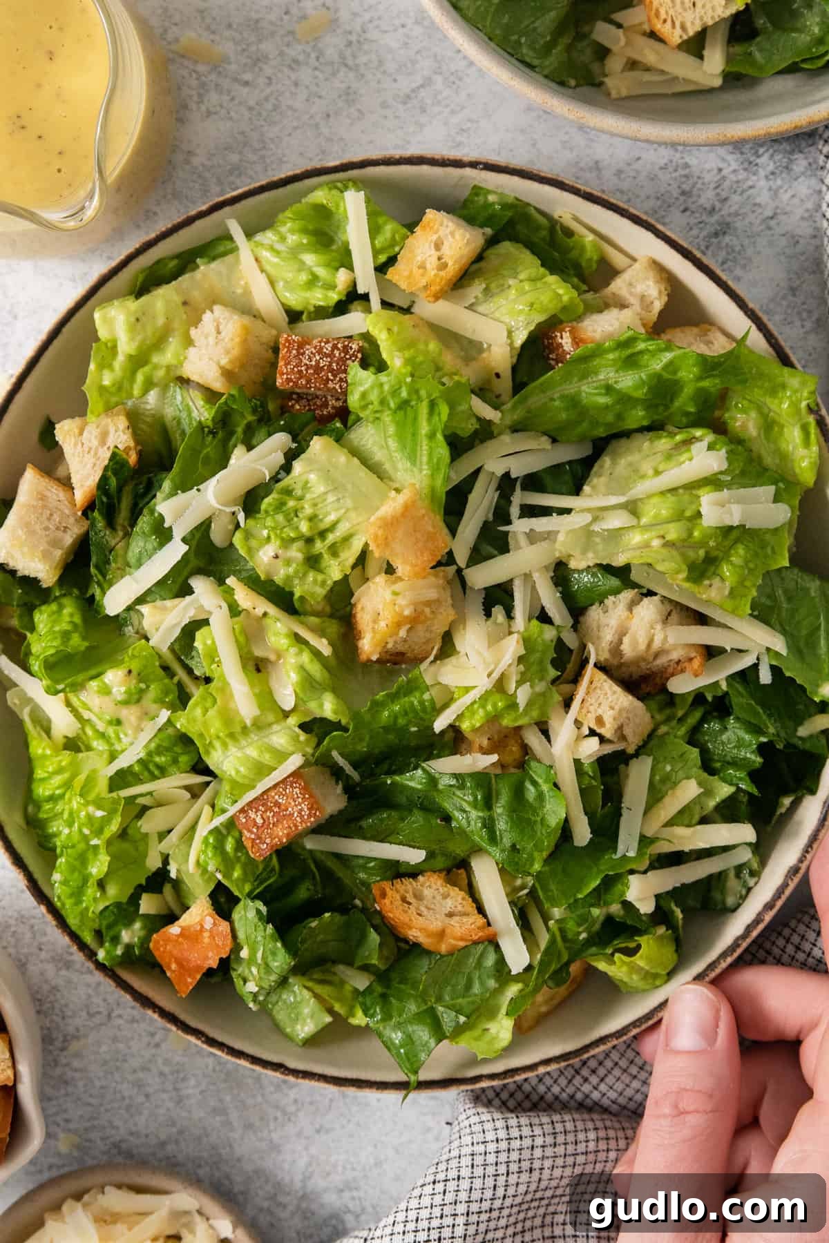 A bountiful serving of Caesar salad, generously dressed and topped with golden croutons, ready for an exquisite dining experience.