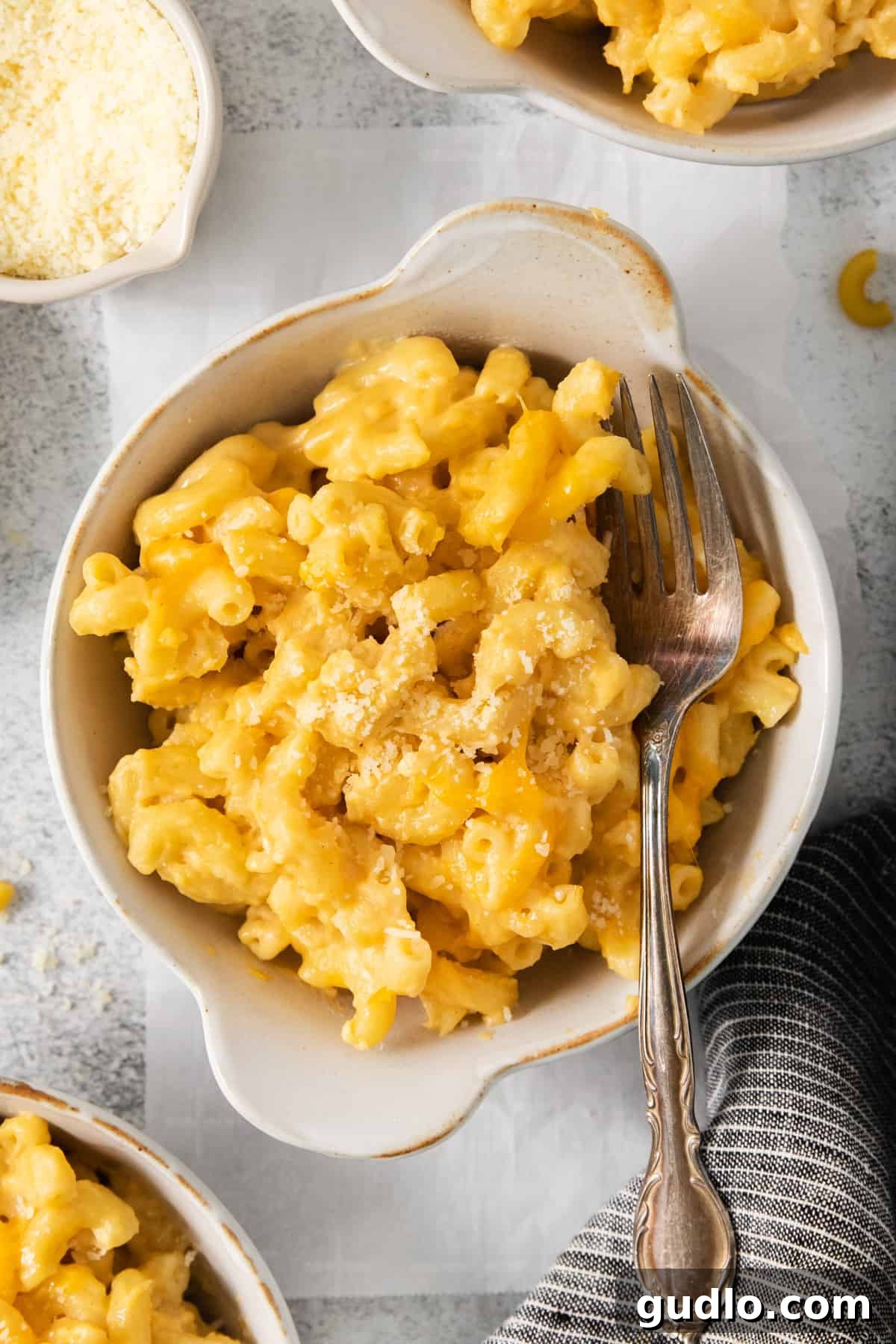 The Ultimate Chick-Fil-A Mac and Cheese Clone 6 Macaroni and cheese in a bowl with a fork, ready to be enjoyed.