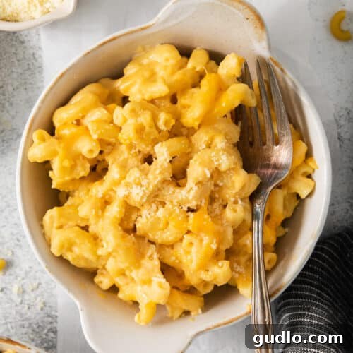 The Ultimate Chick-Fil-A Mac and Cheese Clone 7 Macaroni and cheese in a bowl with a fork, showing the creamy texture and inviting presentation.