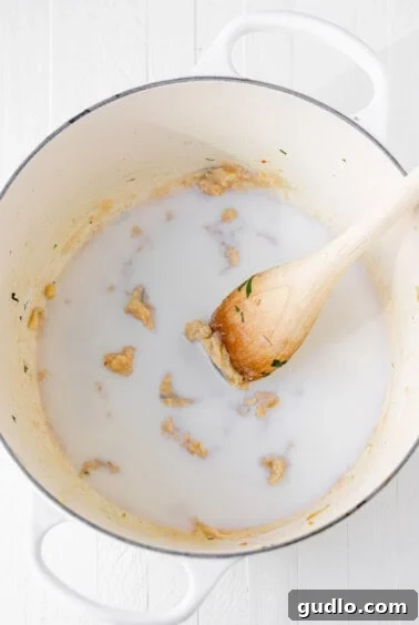 The initial stage of preparing a roux in a pot, with melted butter and flour, showing the start of a creamy, flavorful sauce.