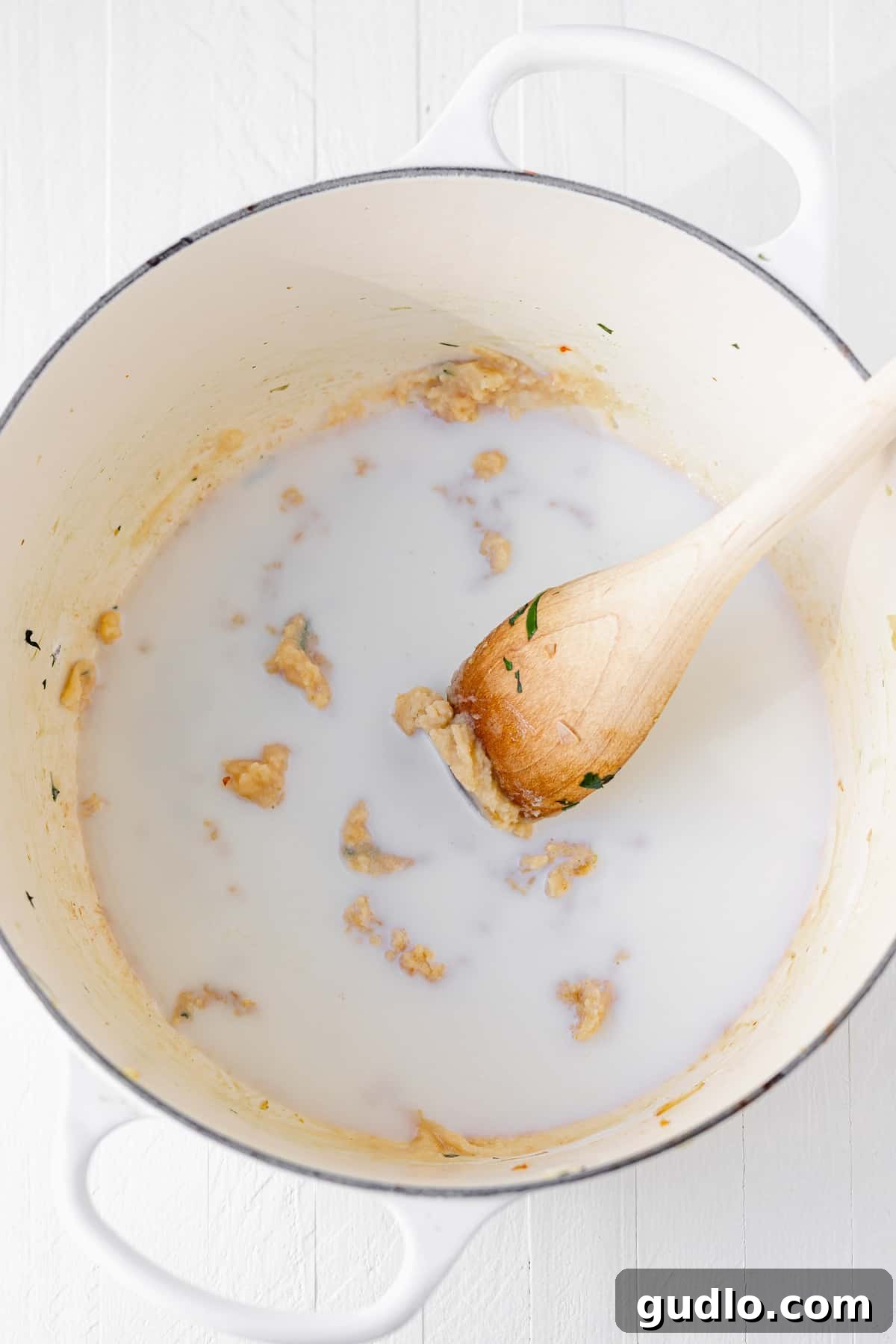 The start of something delicious: preparing the roux for the Tuscan Chicken Mac and Cheese sauce, laying the foundation for creamy perfection. A close-up of butter and flour in a stock pot, the initial ingredients for creating a rich cheese sauce and forming a roux.