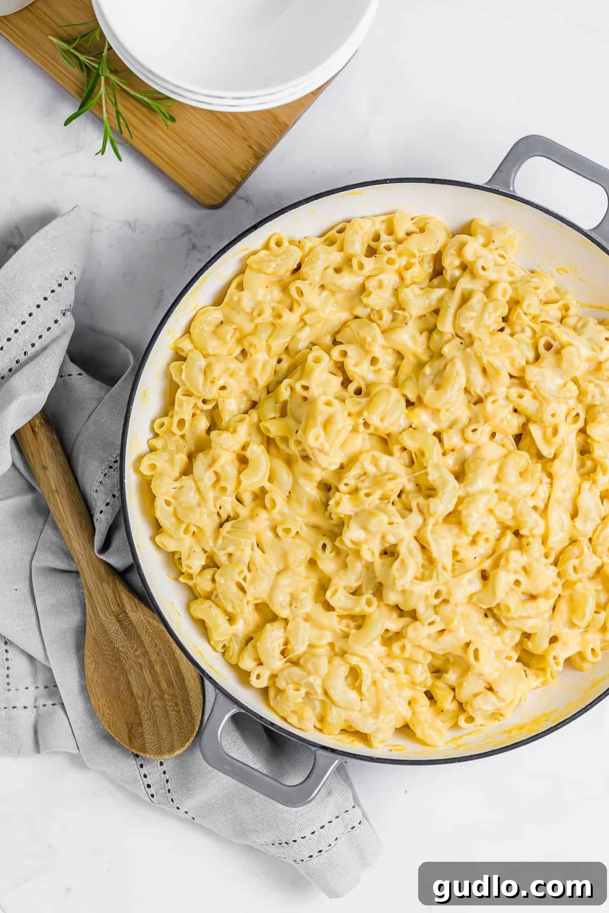 Say hello to the BEST mac and cheese on the internet! This Classic Mac and Cheese recipe is cheesy, creamy and made completely on the stovetop. Enjoy! A large pan filled with golden, bubbling mac and cheese, ready to be served and enjoyed by hungry enthusiasts.