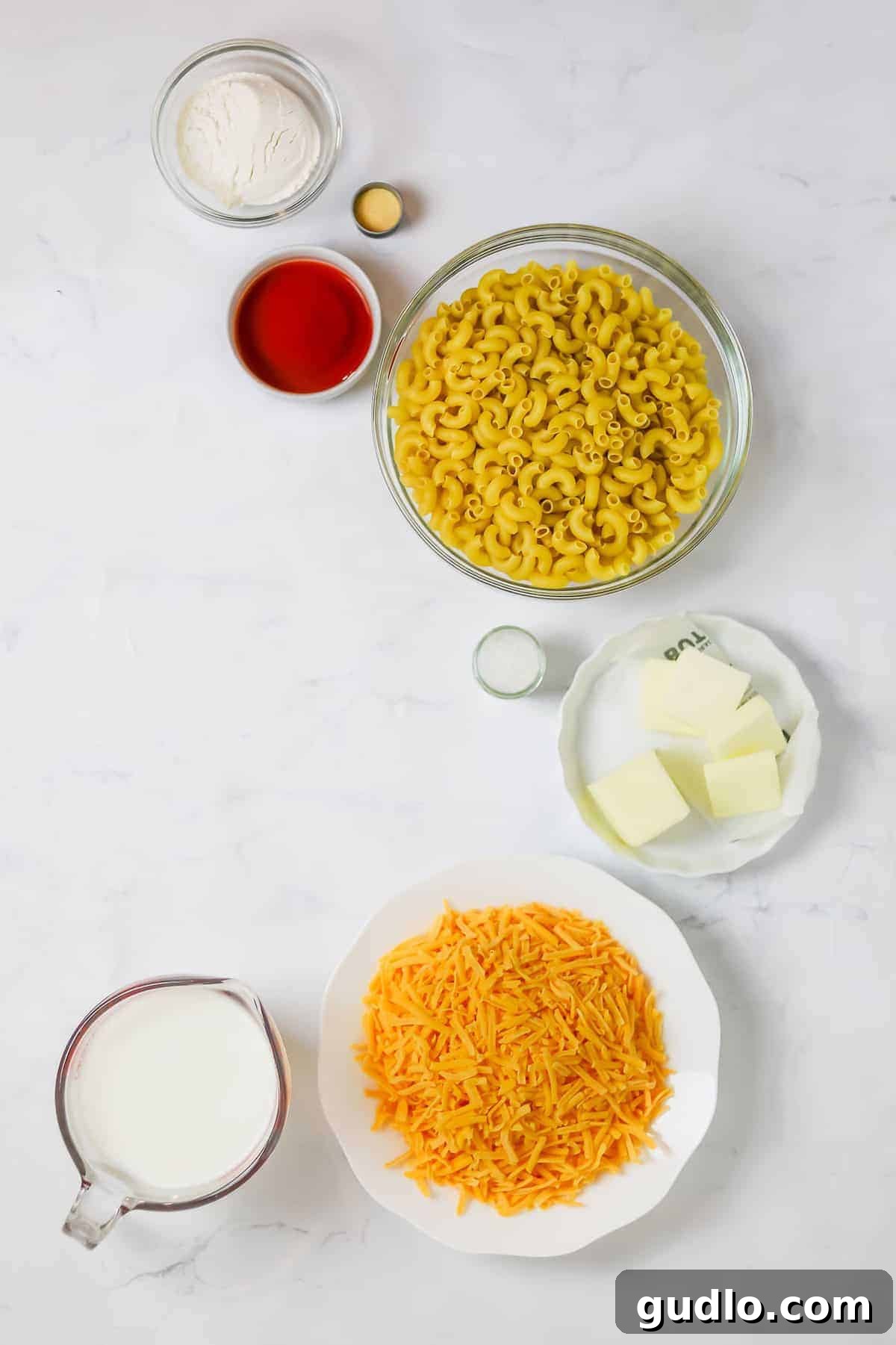 Say hello to the BEST mac and cheese on the internet! This Classic Mac and Cheese recipe is cheesy, creamy and made completely on the stovetop. Enjoy! Various mac and cheese ingredients laid out in bowls, meticulously prepared and ready to be combined for the recipe.