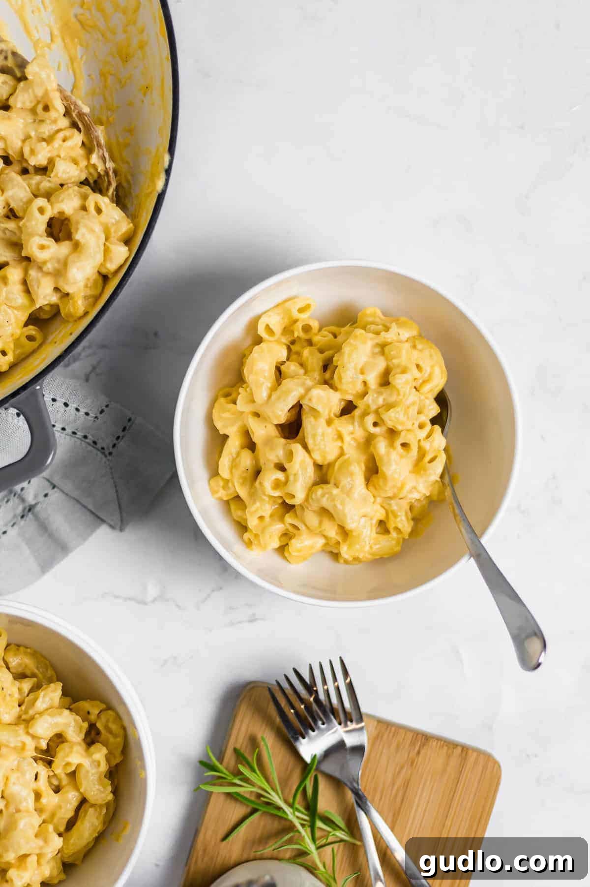 Say hello to the BEST mac and cheese on the internet! This Classic Mac and Cheese recipe is cheesy, creamy and made completely on the stovetop. Enjoy! A inviting bowl of mac and cheese, with a fork poised, ready for a delicious indulgence.