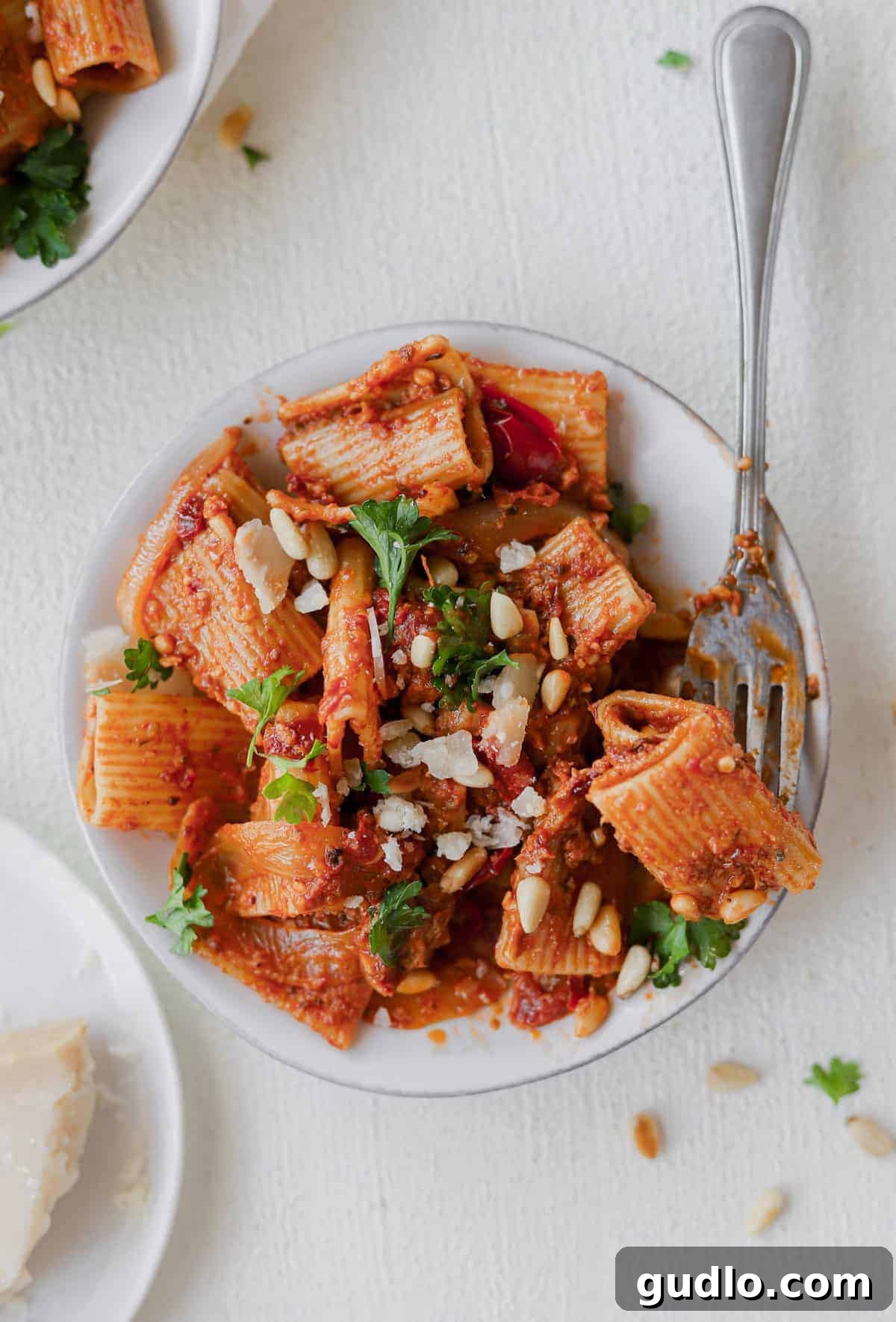 sun dried tomato pasta on plate with fork, perfectly twirled and ready to eat