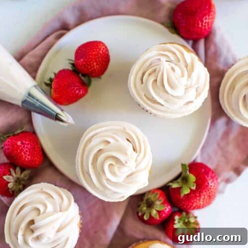 strawberry cream cheese frosted cupcakes on a plate