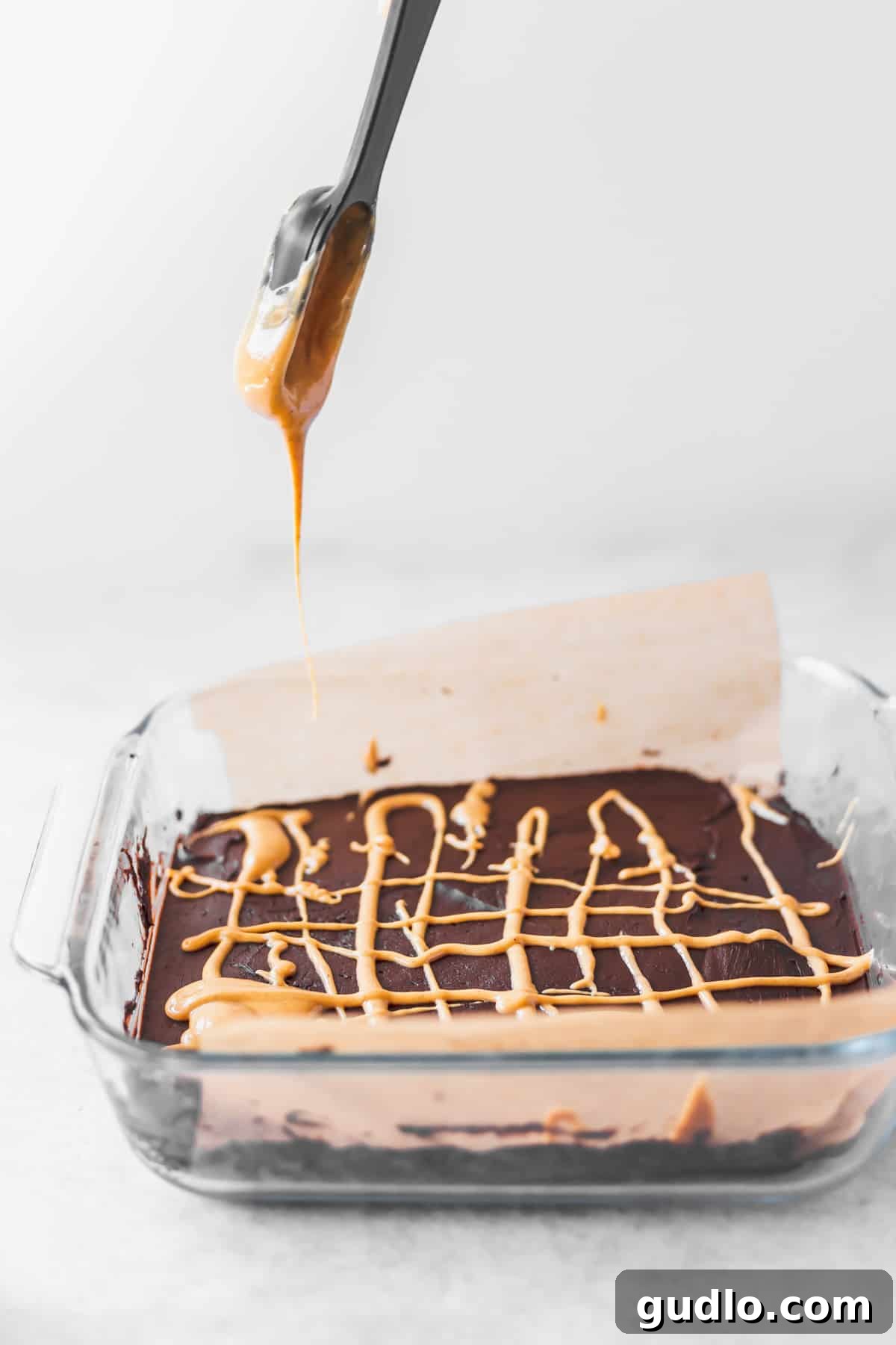 Peanut Butter Chocolate Cheesecake Fudge 4 A perfectly set batch of cream cheese fudge in an 8x8-inch dish, ready to be sliced and served.