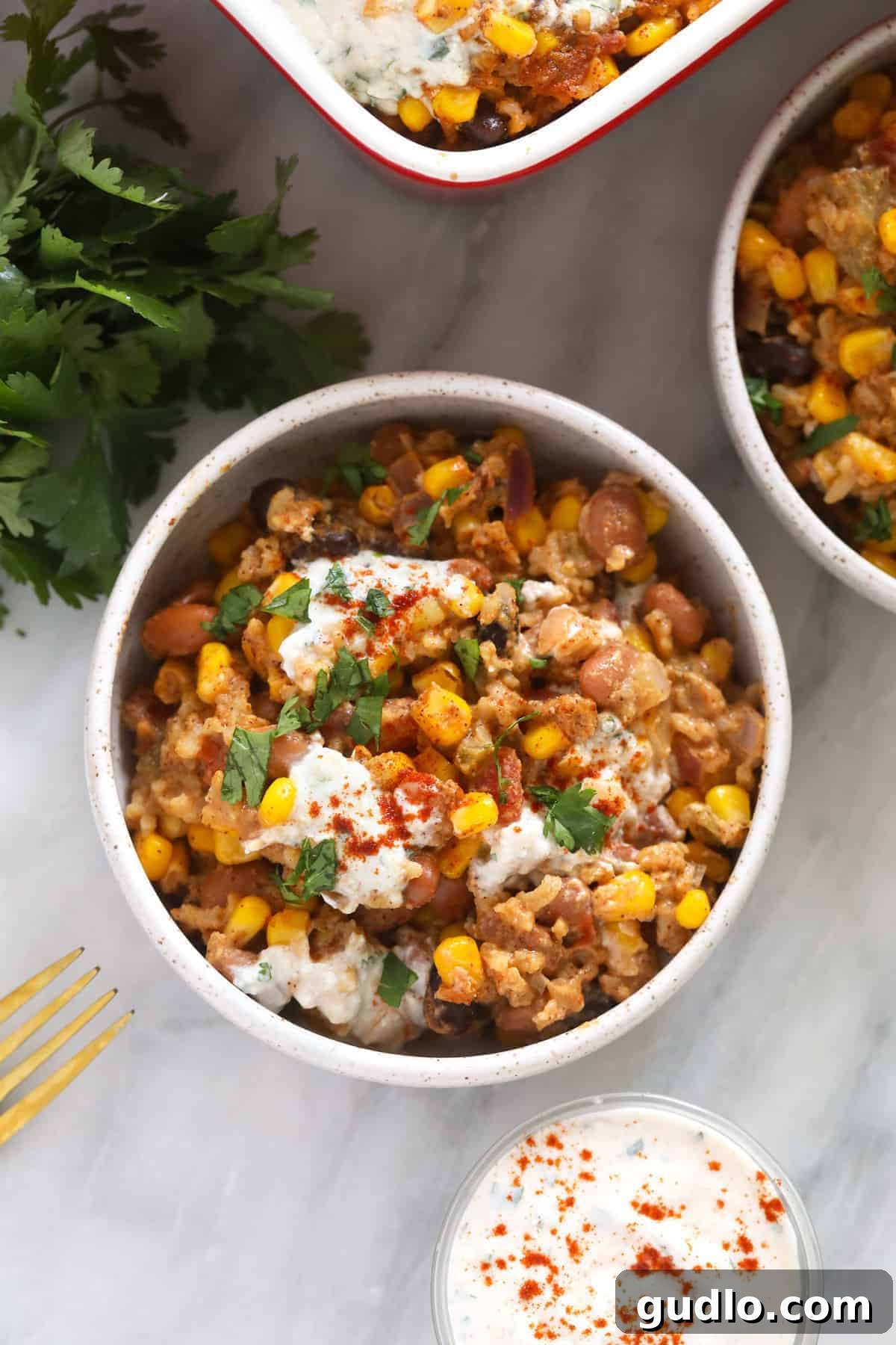 A comforting bowl of Mexican Street Corn Casserole, perfect for any meal. A bowl of hot, creamy Mexican street corn casserole, ready to be enjoyed as a comforting and flavorful meal.