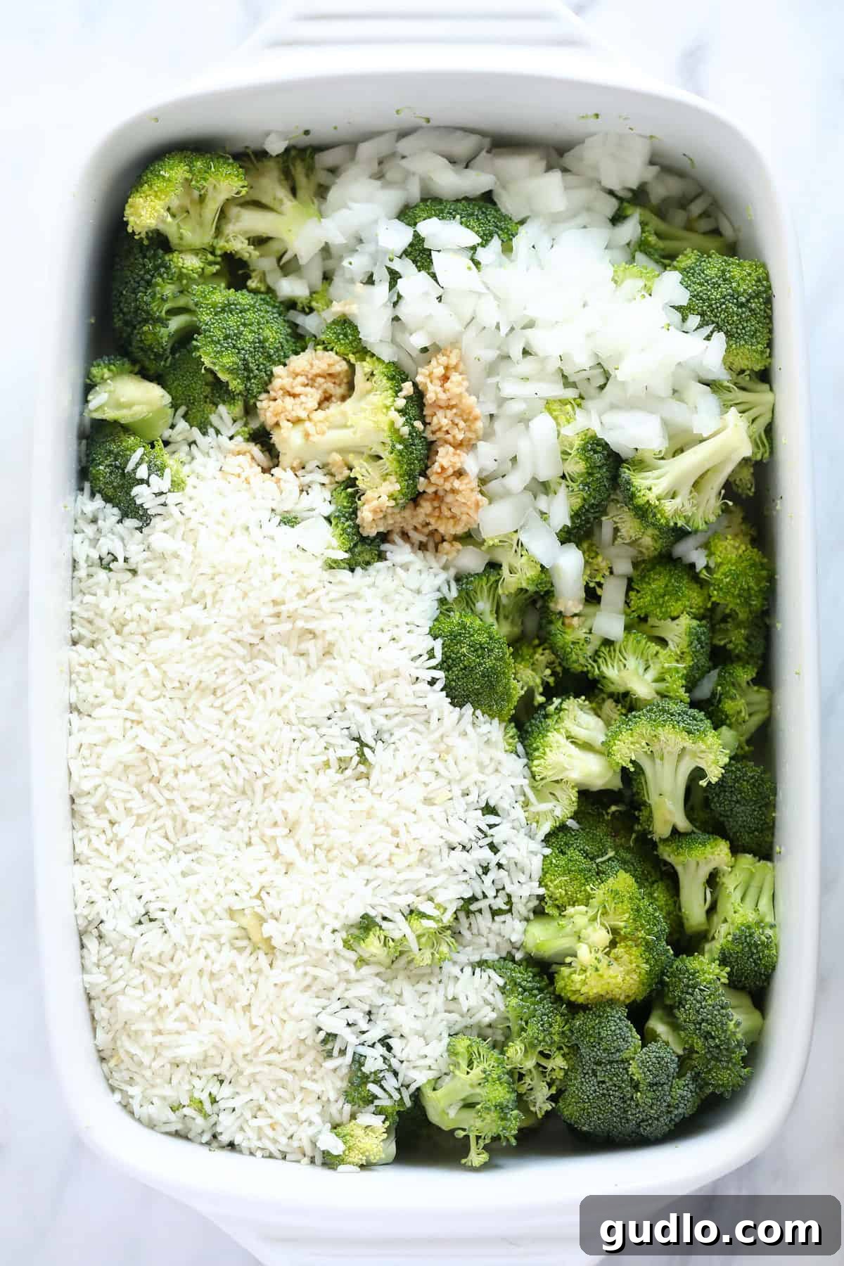 A vibrant display of fresh ingredients in a casserole dish, ready to be mixed for a delicious broccoli and cheese bake.